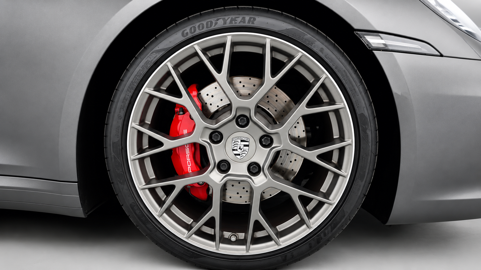 Detail of the Porsche 911 Carrera S wheel and red brake caliper