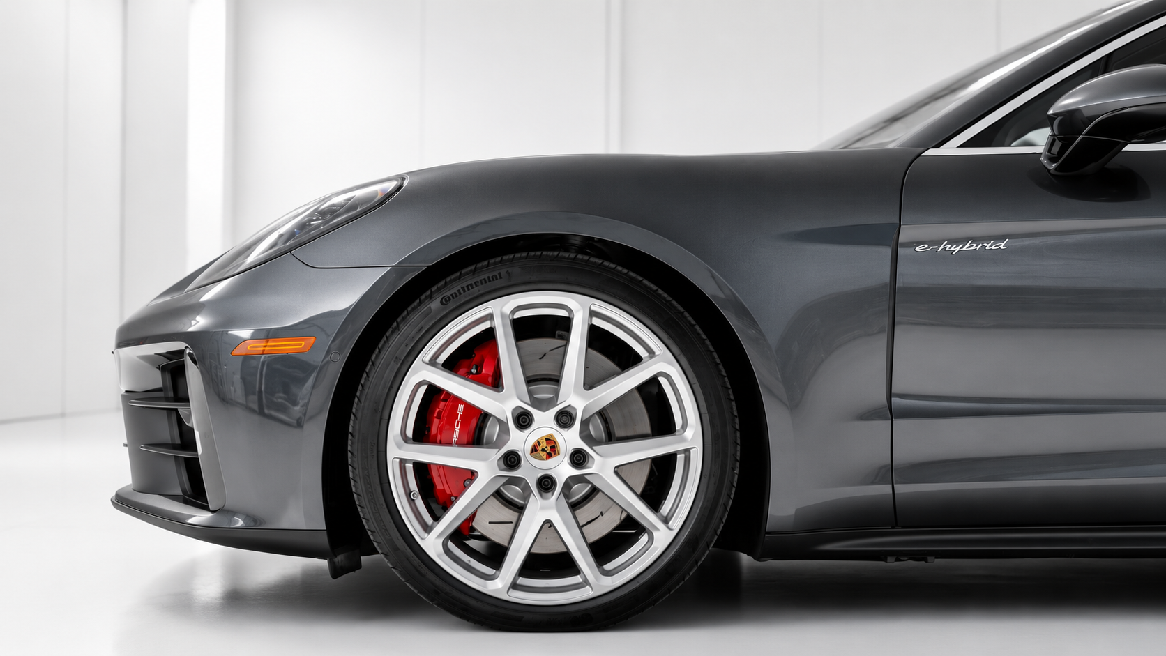 Detail of the Porsche Panamera 4S wheel and red brake caliper